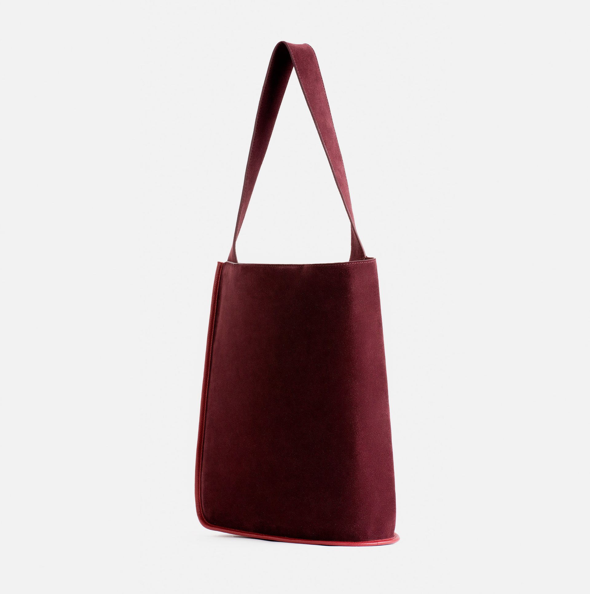 Eileen wraparound pebble leather shoulder bag in claret red / red currant