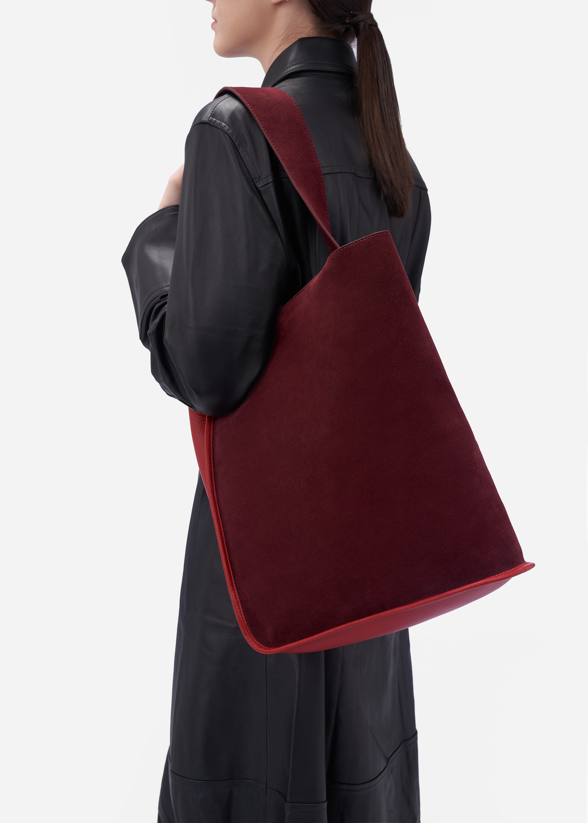 Eileen wraparound pebble leather shoulder bag in claret red / red currant
