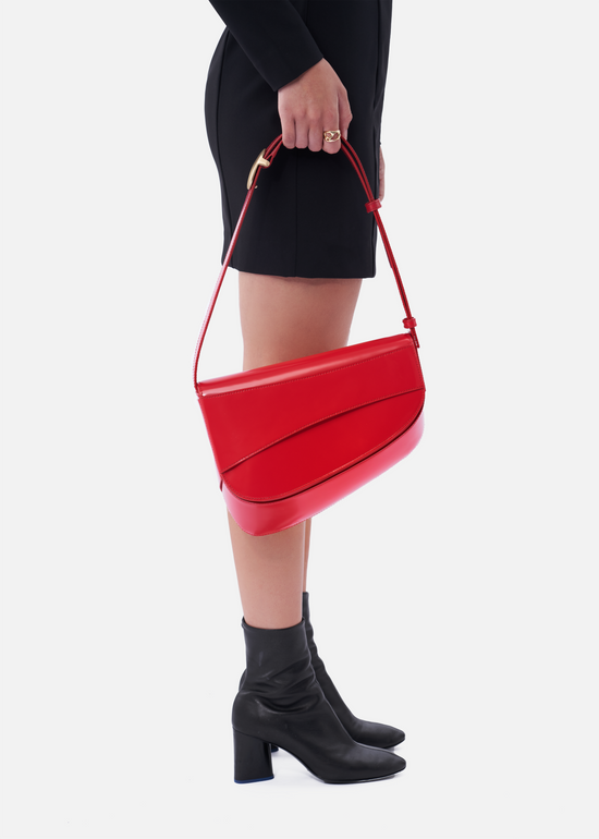 Grete pebble leather shoulder bag in black / caramel with red edge pai - ro  bags